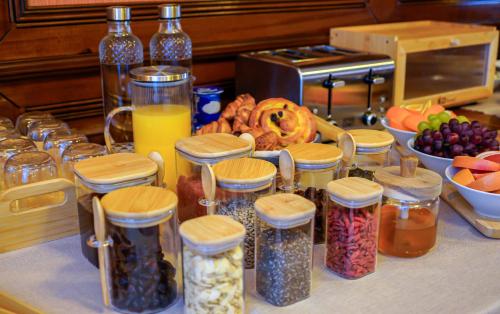 a counter with jars of food and a bunch of fruit at Bark Inn - Bed and Breakfast in Braşov
