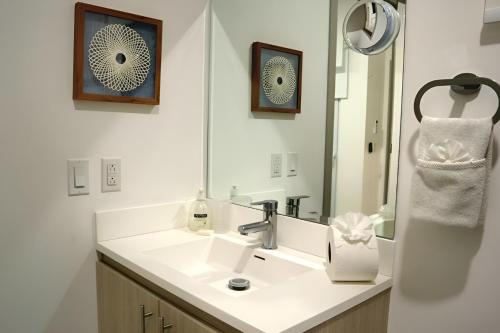 a bathroom with a sink and a mirror at Tranquil Tides Costa Rica in Pochote