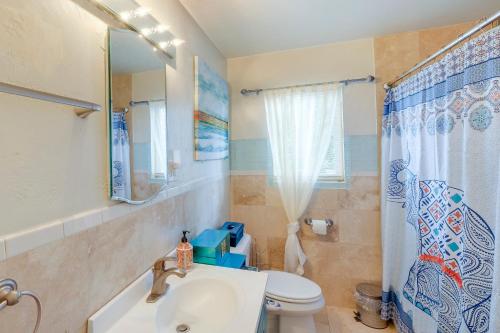 a bathroom with a sink and a toilet and a mirror at Dog-Friendly California Home with Patio, Near Hiking in La Mesa
