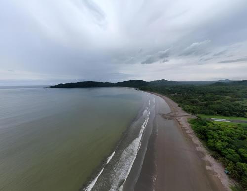 an aerial view of a beach and the ocean at Tranquil Tides Costa Rica in Pochote