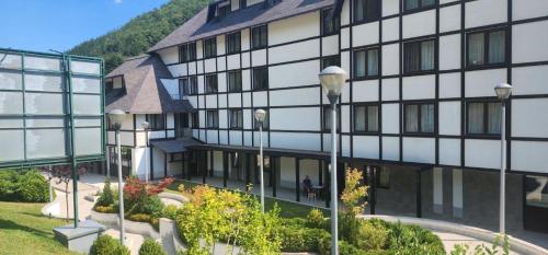un edificio con una persona sentada fuera de él en Brzece lux apartman, en Brzeće