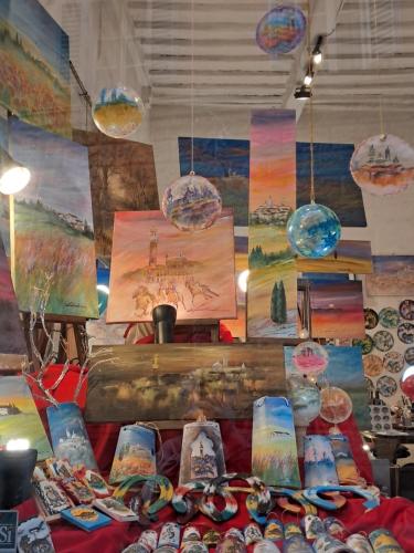 a table with paintings and other items on it at Hotel Minerva in Siena