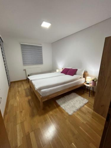 a bedroom with a large bed in a room at Montis Vlasic Apartment 2 in Vlasic