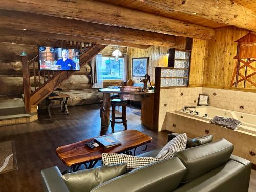 a living room with a couch and a tv and a tub at Soap Lake Natural Spa & Resort in Soap Lake