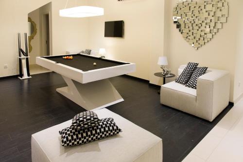 a living room with a pool table and a couch at Nacala Plaza Business Design Hotel in Cidade de Nacala