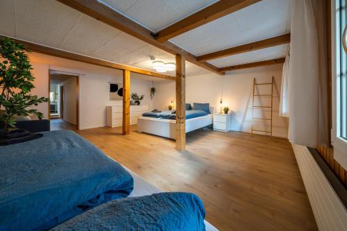 a bedroom with two beds and a ladder at Large apt in town center next to Brunngasse & near lake in Brienz