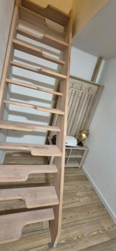 a staircase in a house with wooden steps at Maison à AY Epernay, 3 Bed Rooms House, 3 chambre in Ay