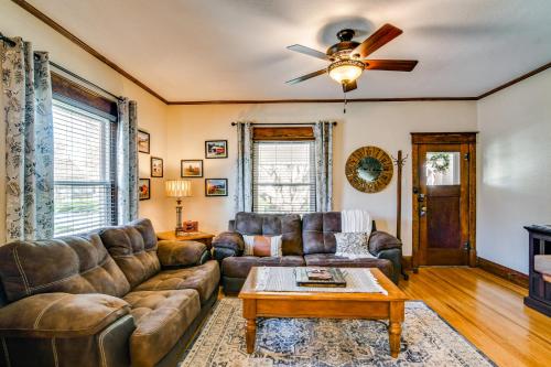 a living room with a couch and a ceiling fan at Charming Winterset Vacation Rental with Yard and Patio in Winterset