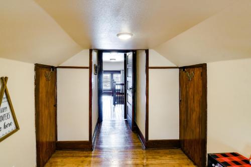 an empty hallway with wooden doors and wood floors at Charming Winterset Vacation Rental with Yard and Patio in Winterset