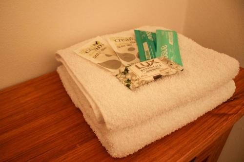 a pile of towels sitting on top of a table at Natullins Apartment in Ezeiza