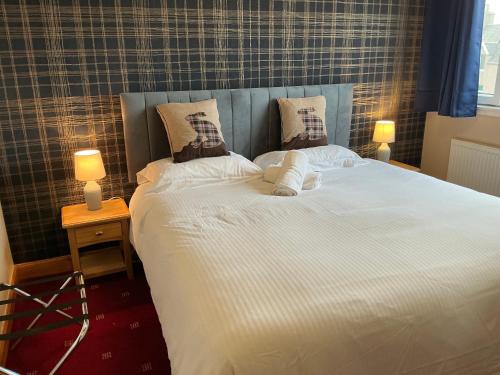 a large white bed with two pillows on it at Seaview John O Groats Hotel in John O Groats