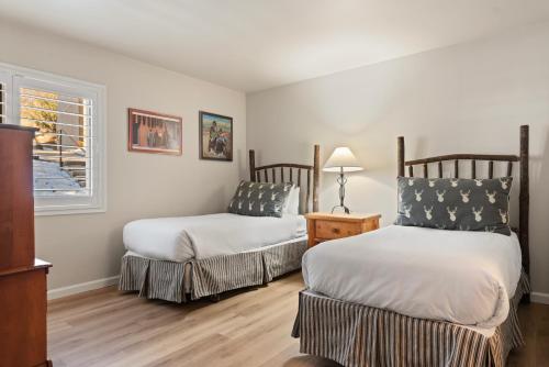 a bedroom with two beds and a window at Woodbridge Condo by Snowmass Vacations in Snowmass Village