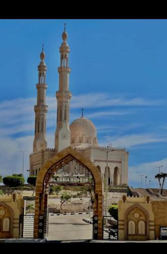 a mosque with a gate in front of it at Happy house Aswan in Aswan
