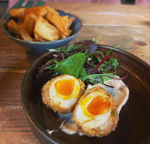 a plate of food with eggs and french fries at Seaview John O Groats Hotel in John O Groats