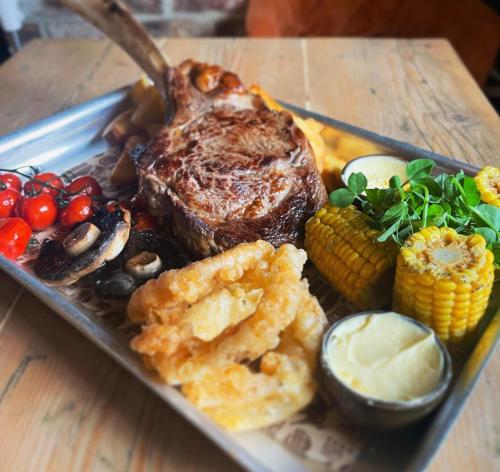 a plate of food with steak and vegetables on a table at Seaview John O Groats Hotel in John O Groats