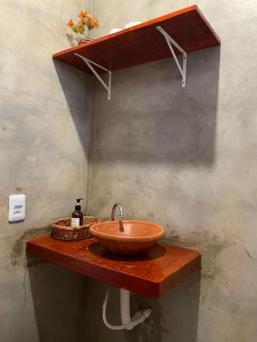 a bathroom with a bowl sink on a wooden table at Villa Careca in Luis Correia