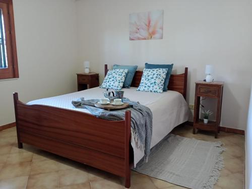 a bedroom with a bed with a table on it at Villa la Pineta in Arenella