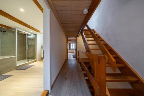 a staircase in a house with a wooden ceiling at Large apt in town center next to Brunngasse & near lake in Brienz