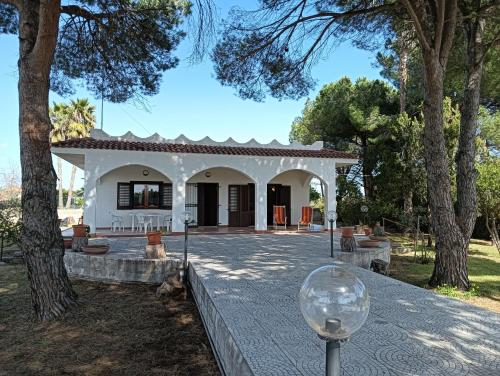 a wine glass sitting in front of a house at Villa la Pineta in Arenella