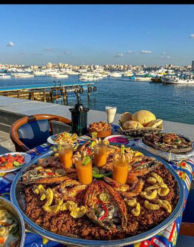 a table with a bunch of seafood and drinks at Happy house Aswan in Aswan