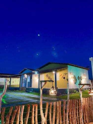 a building with lights in front of it at night at Villa Careca in Luis Correia