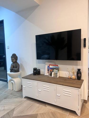 a living room with a large television on a wall at La Bohème Mouriès in Mouriès