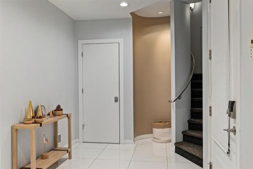 a hallway with a white door and a staircase at Piermont Waterfront Villa with Hot Tub in Piermont