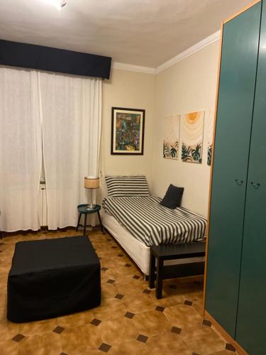 a bedroom with a bed and a ottoman at La casa di Nana’ in Pisa