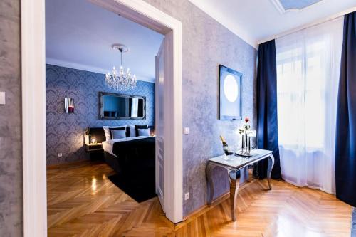 a living room with a couch and a table in a room at Sophie's Place Augarten - Lifestyle City Apartments Vienna Parking in Vienna