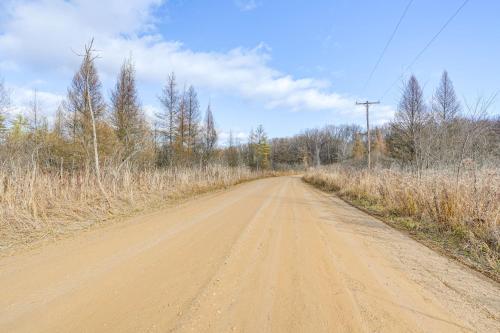 a dirt road in the middle of a field at Secluded Home with Lake View in Delton! in Delton