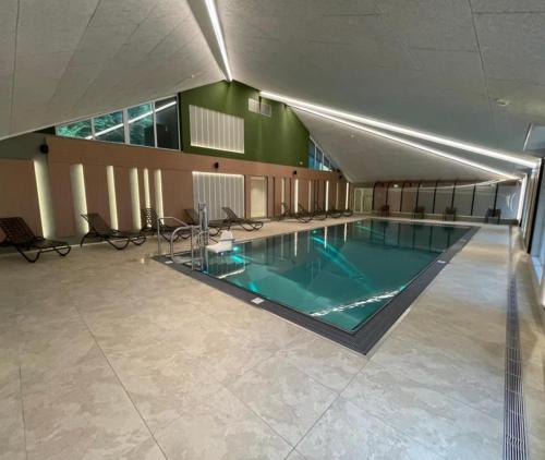 a large swimming pool in a large building at Apartment Schladming mit Sauna und Pool in Schladming