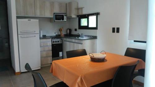 a kitchen with a table with a bowl on it at Casitas del Lago in Potrero de Garay