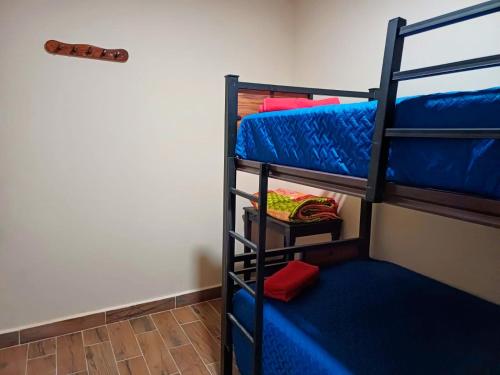 a bunk bed room with two bunk beds and a staircase at Casa Victoria in San Cristóbal de Las Casas