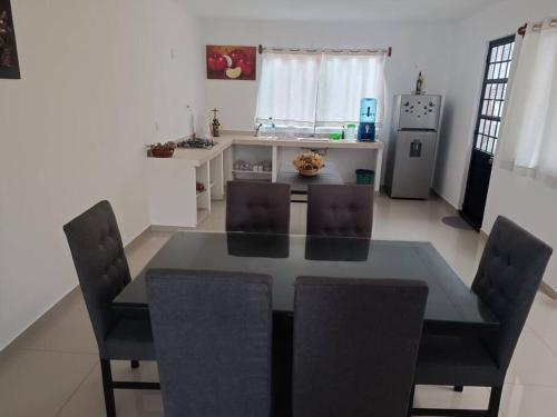 a kitchen with a dining room table and chairs at Casa Vacacional in Uruapan del Progreso