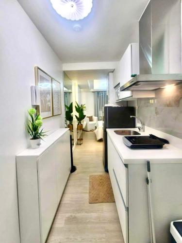 a kitchen with a sink and a counter top at Azure North Amirah’s Place in San Fernando
