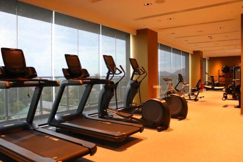 a gym with treadmills and elliptical machines at Palm Springs Hotel Dili in Dili