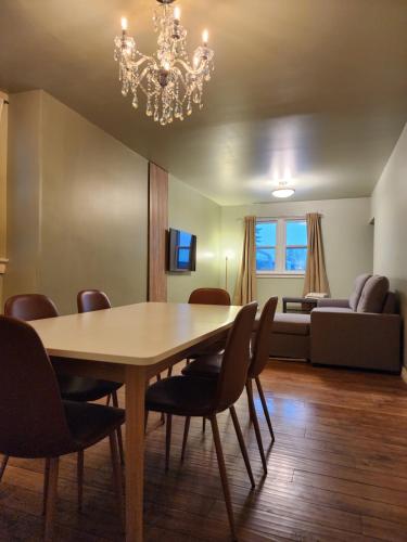 a dining room with a table and chairs and a couch at 2-bed house for downtown, stampede & mountains in Calgary