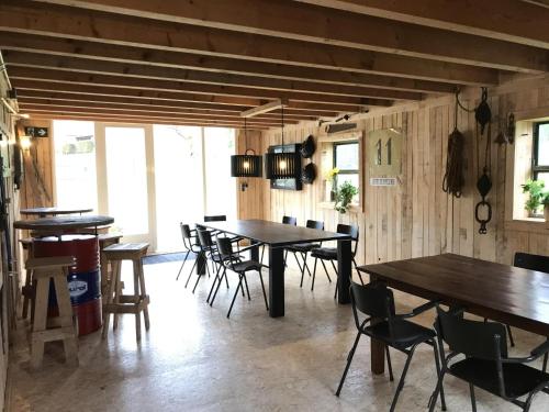a dining room with wooden tables and chairs at Grutsk in Altenstädt