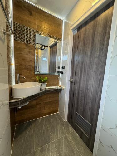 a bathroom with a tub and a sink and a mirror at Rinda House in Patong Beach