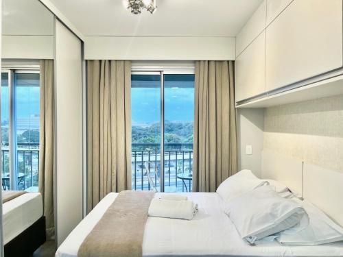 a bedroom with a large bed and a balcony at Flat WiseSP - Expo Anhembi in Sao Paulo