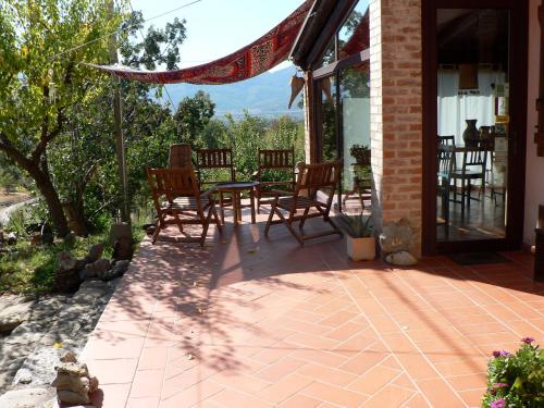 a patio with chairs and a table on a house at Azienda Agricola Il Querceto in Marsico Vetere