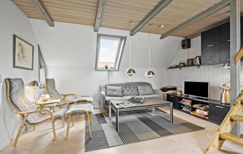 a living room with a couch and a table and chairs at 3 Bedroom Beautiful Home In Ringkøbing in Ringkøbing