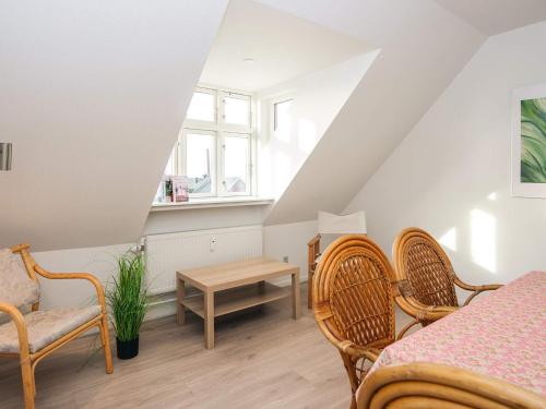 a room with chairs and a table and a window at 2-room apartment in Denmark in Ringkøbing