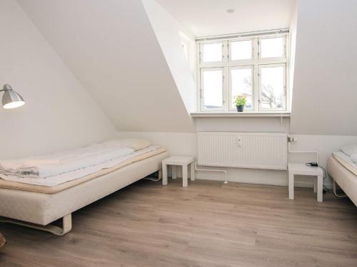 a bedroom with two beds and a window at 2-room apartment in Denmark in Ringkøbing
