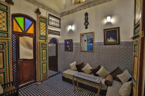 a living room with a couch in a room at Riad Skilfo in Fès