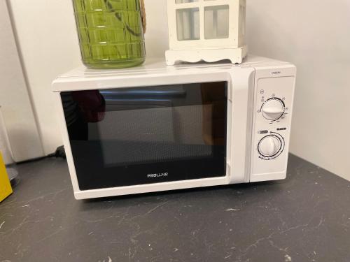 a white microwave with a blender on top of it at Cosy appart en plein centre - 2 guests in Colmar