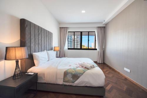 a bedroom with a large bed and a window at The Landmark Seaview Suite in Tanjong Tokong