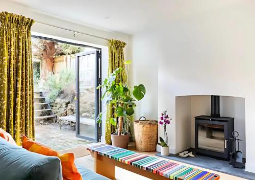 a living room with a couch and a fireplace at Stanley Road - Gorgeous Modern Flat in Oxford! in Oxford
