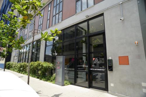 a store front of a building with large glass windows at GREEN ONE - Apto novo, moderno, varanda, poucos passos da estação Luz in Sao Paulo
