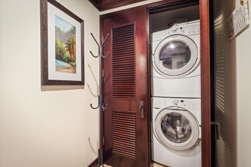 a laundry room with a washer and dryer at Waipouli Beach Resort and Spa Kauai by OUTRIGGER in Kapaa